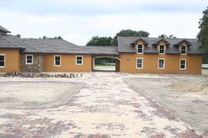 A brick paver driveway in Orlando Florida being sanded under construction